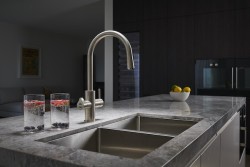 Two glasses of water next to the kitchen sink